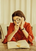 woman holding magnifying glass