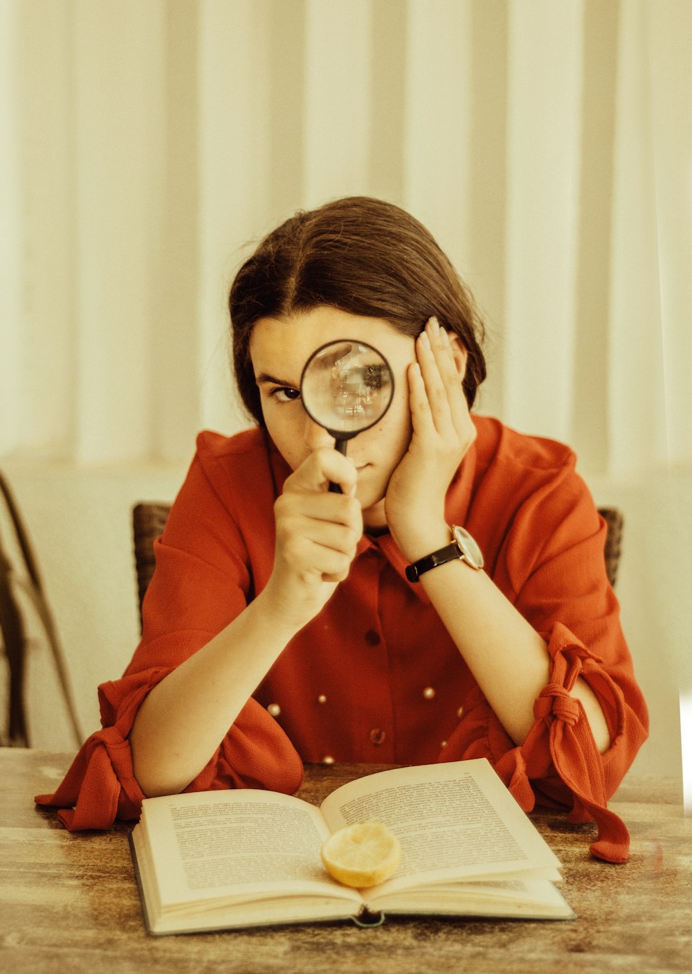 woman holding magnifying glass