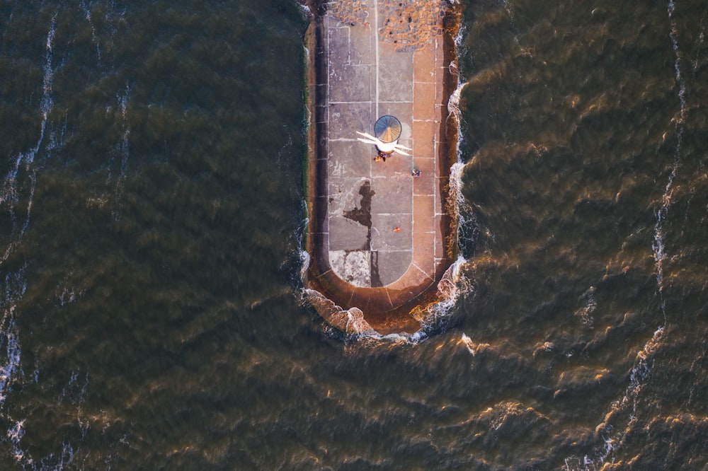 an aerial view of a pier in the water