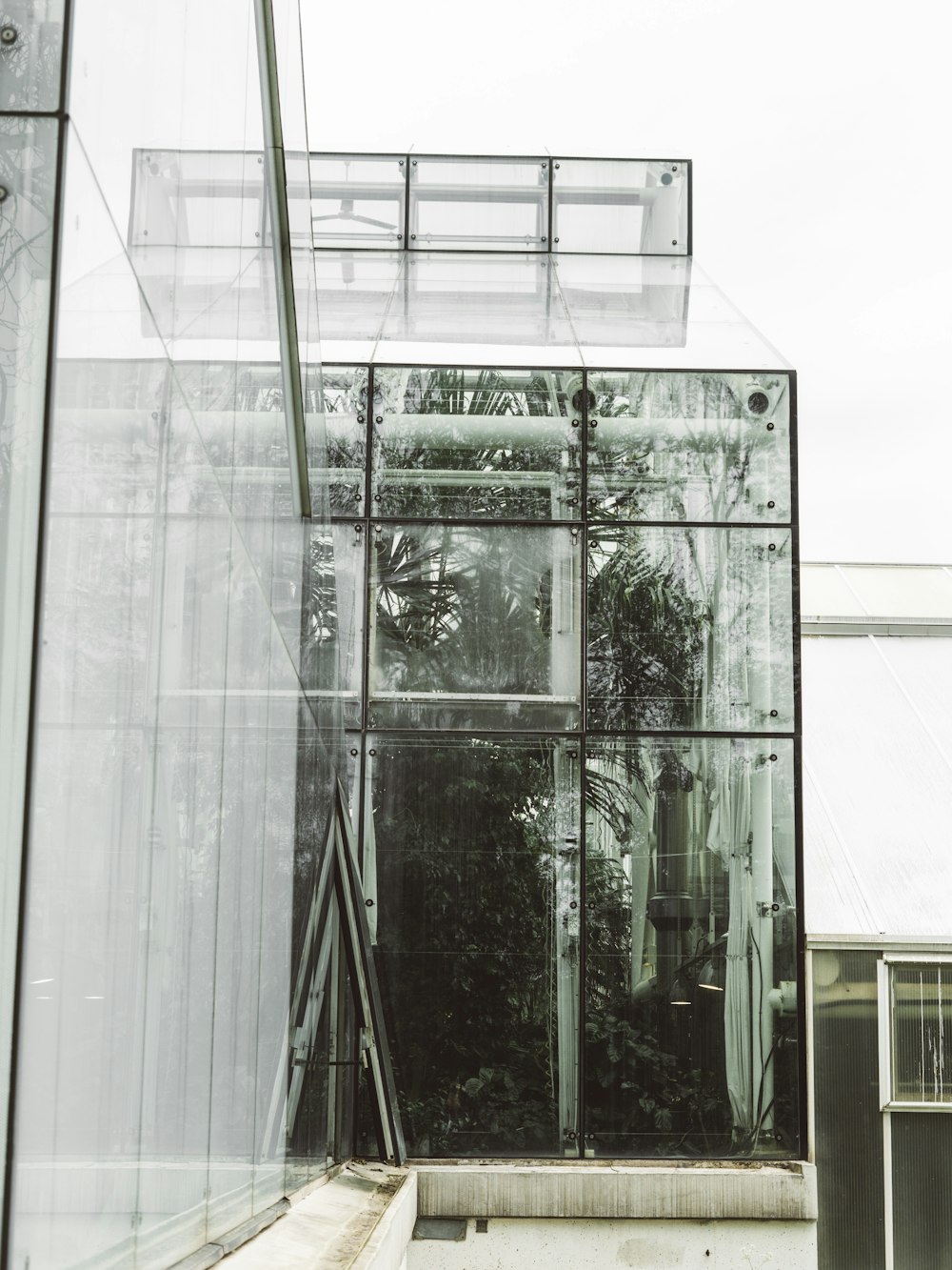 a glass building with a bench in front of it