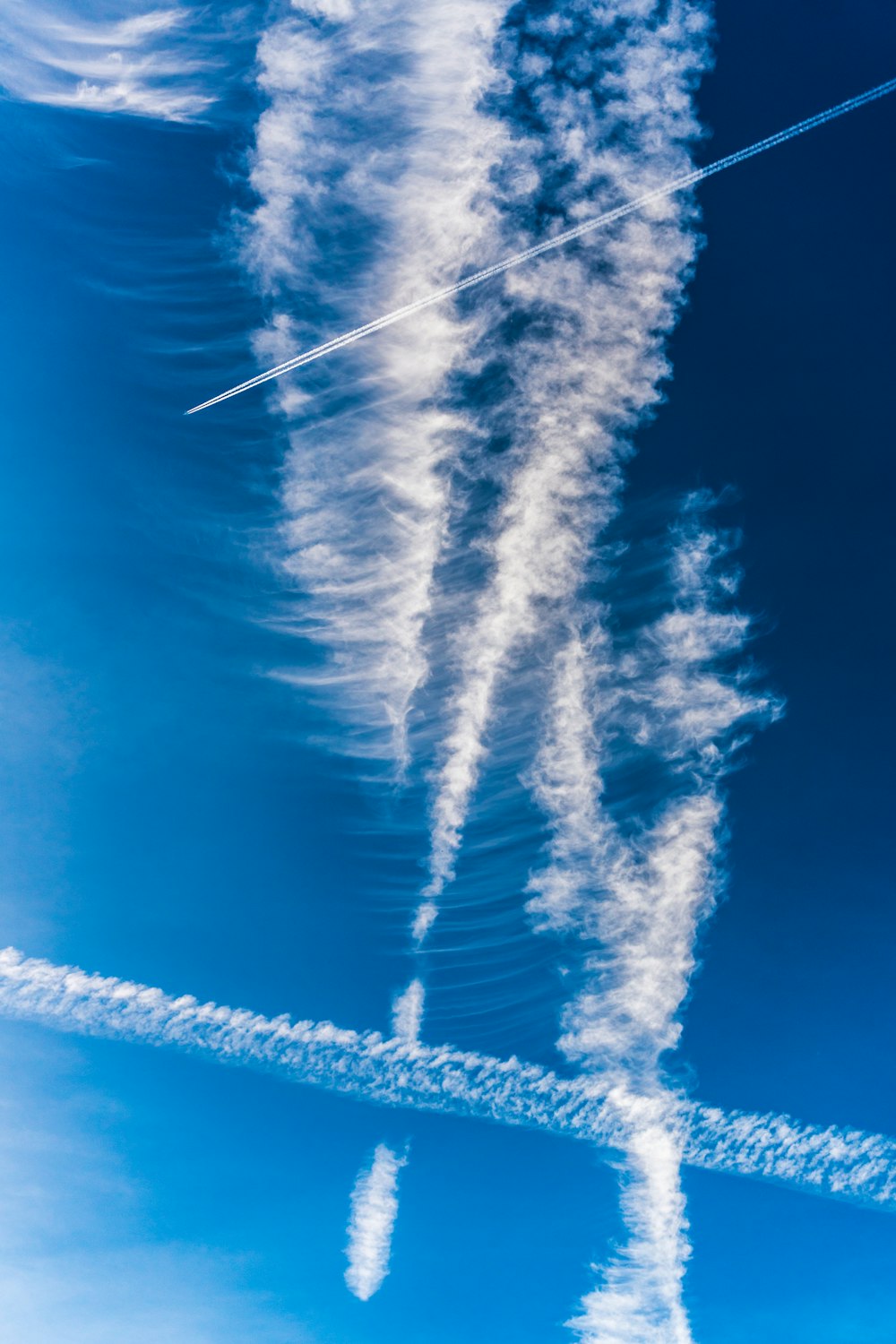 a group of planes flying through a blue sky