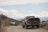 A rugged pickup truck parked on a dirt road.