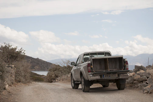 A rugged pickup truck parked on a dirt road.