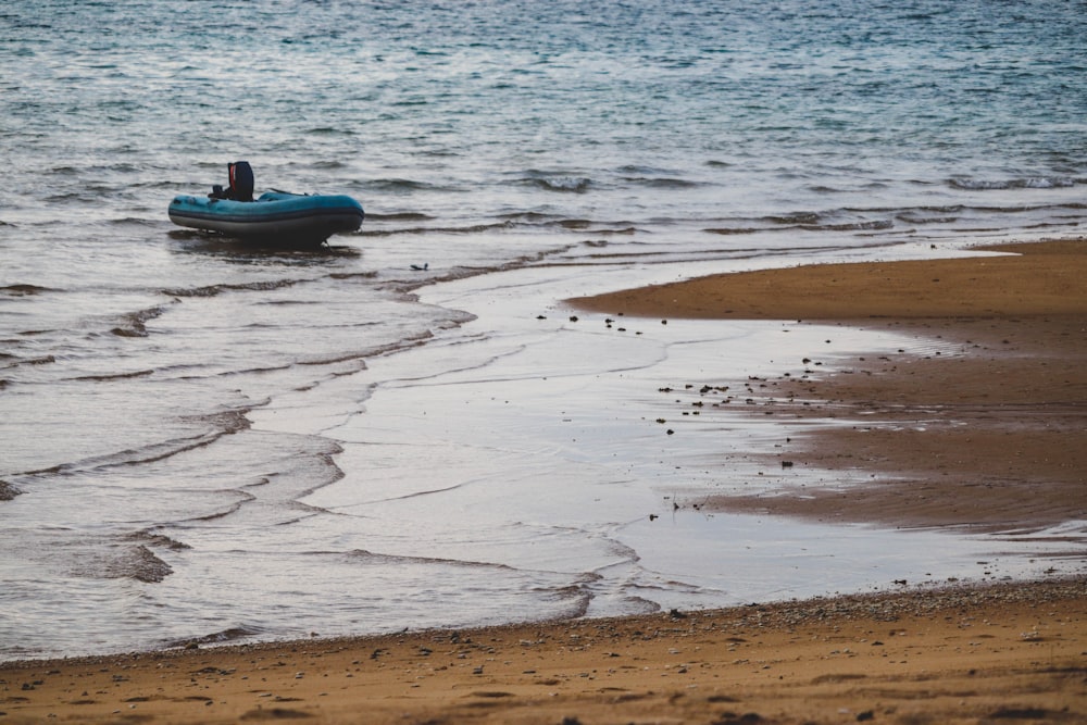 blue inflatable raft on beach