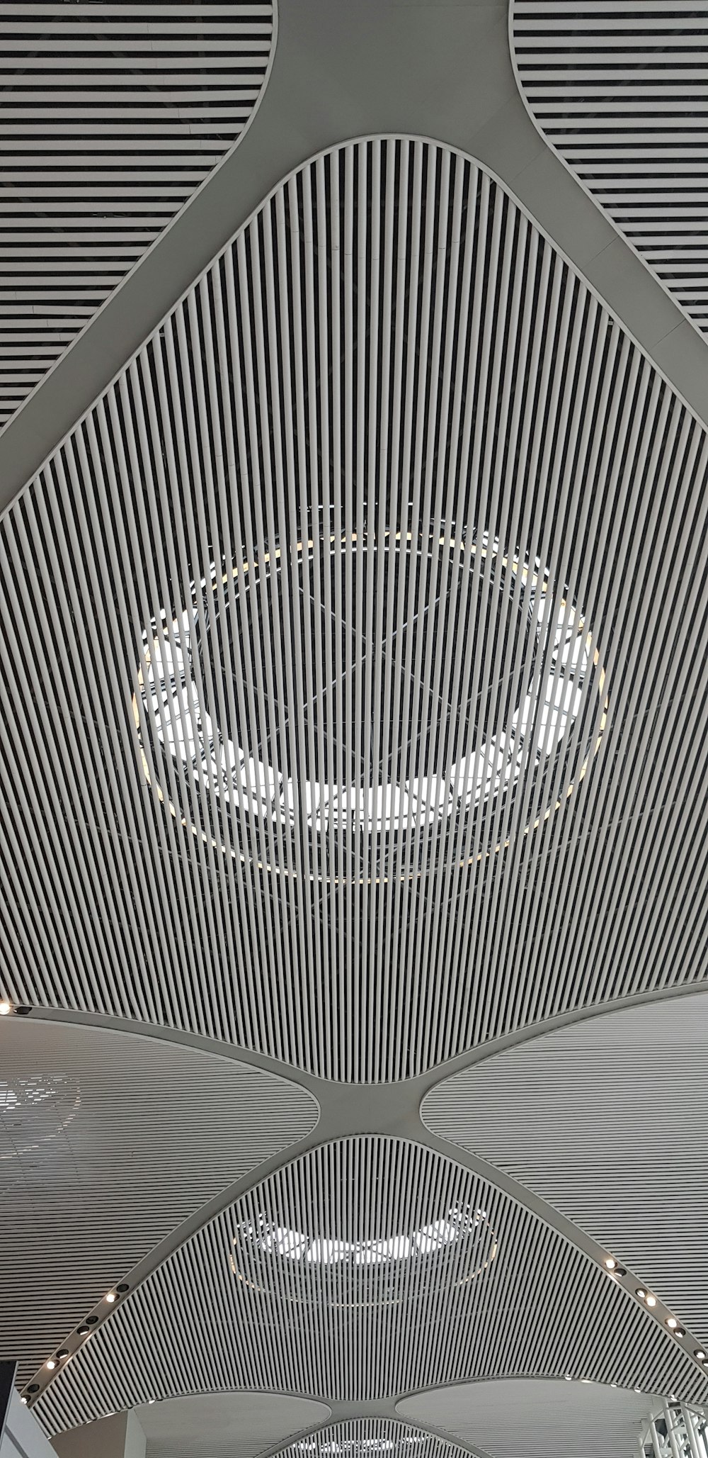 the ceiling of a building with a circular light fixture