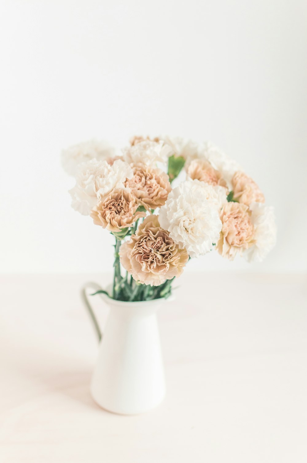 white ceramic flower pitcher