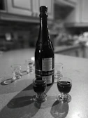 A sophisticated tasting setup with multiple glasses of rum lined up on a polished wooden table.