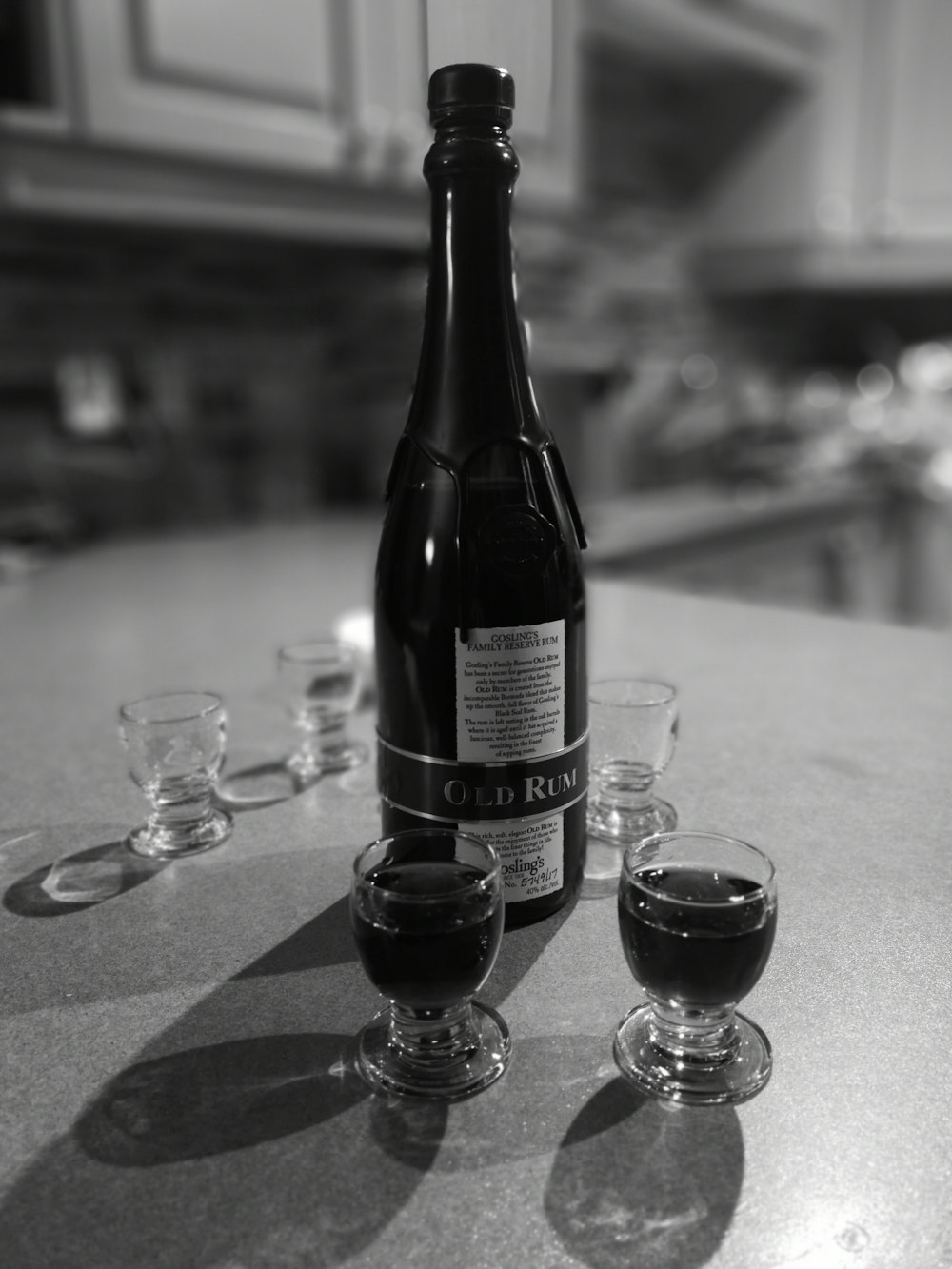 Old Rum bottle and clear shot glasses