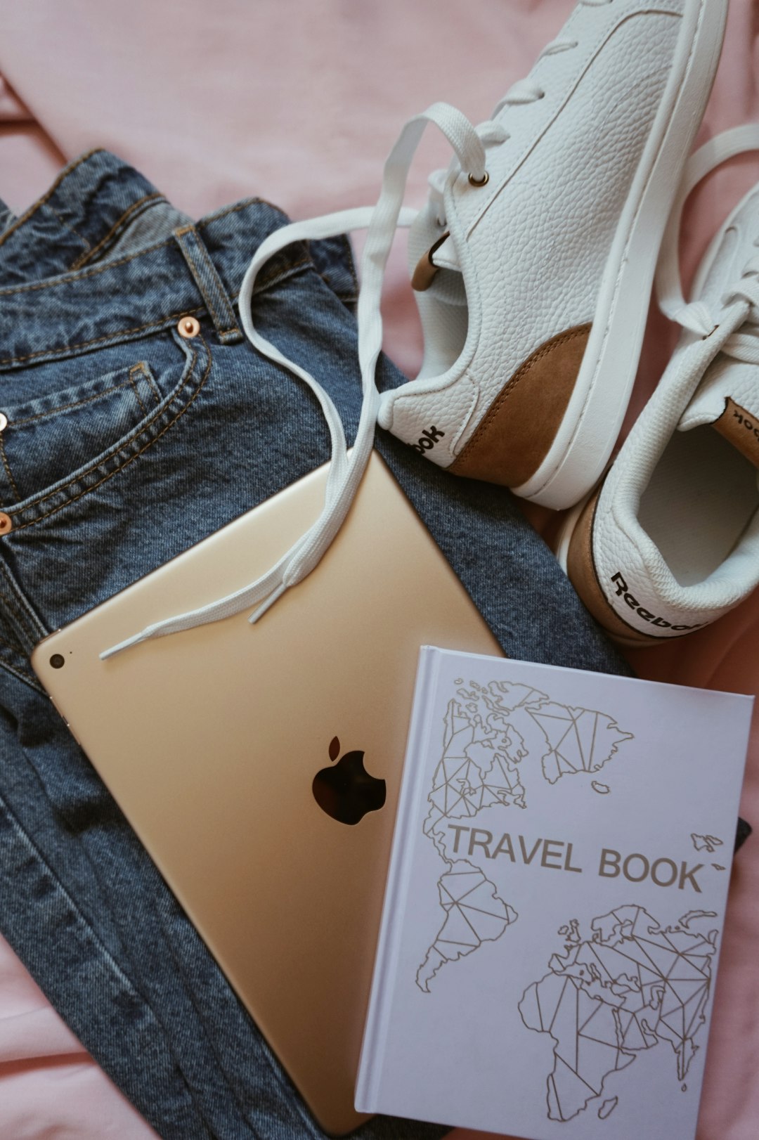 gold iPad and white-and-brown low-top sneakers