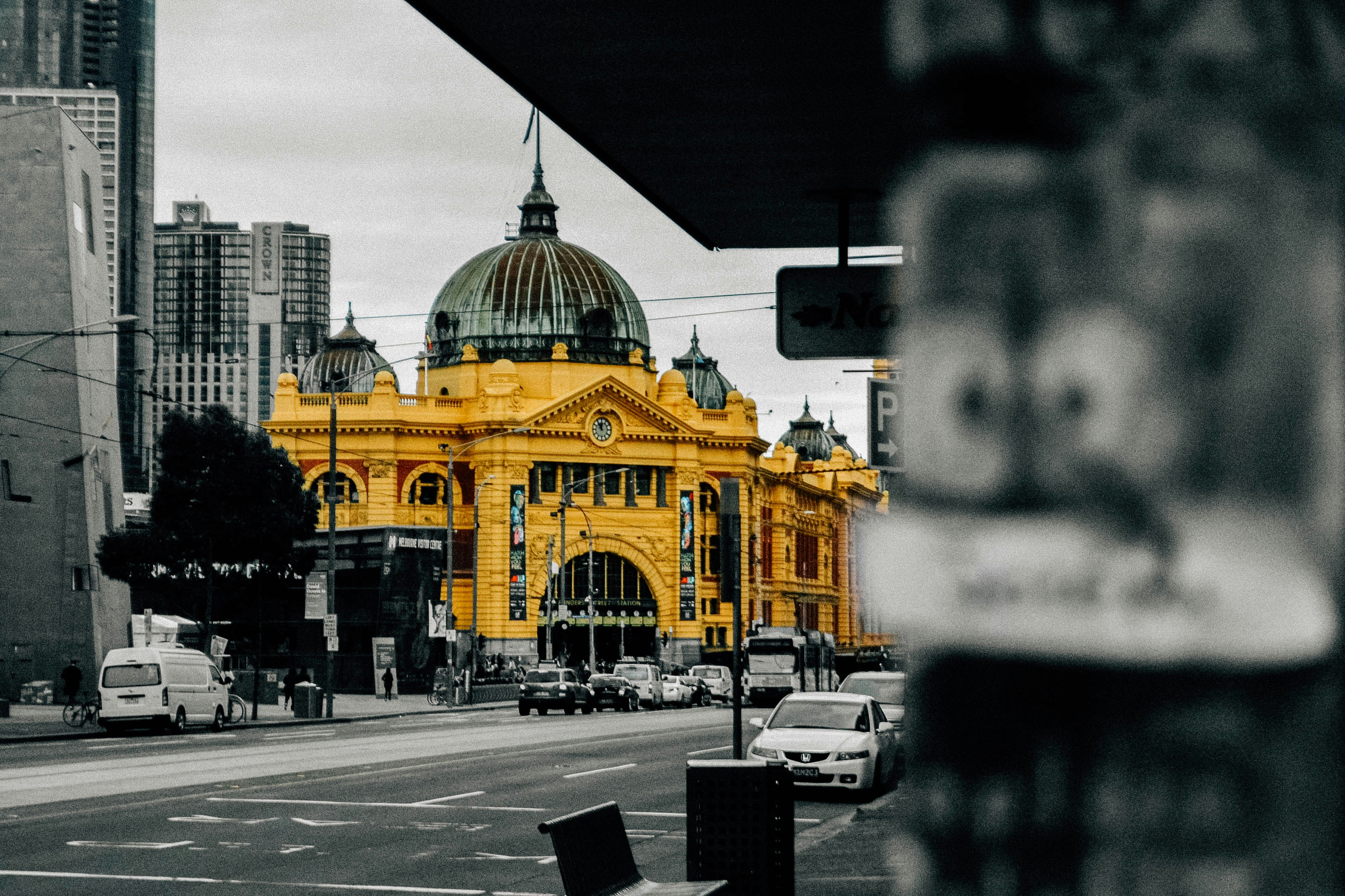 people walking on street and different vehicles on road near buildings, Flinders Street