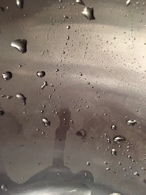 Macro shot of a flawless ceramic coating finish shimmering under soft studio lighting.