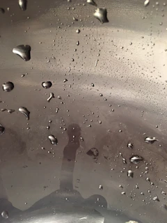 Macro shot of a flawless ceramic coating finish shimmering under soft studio lighting.