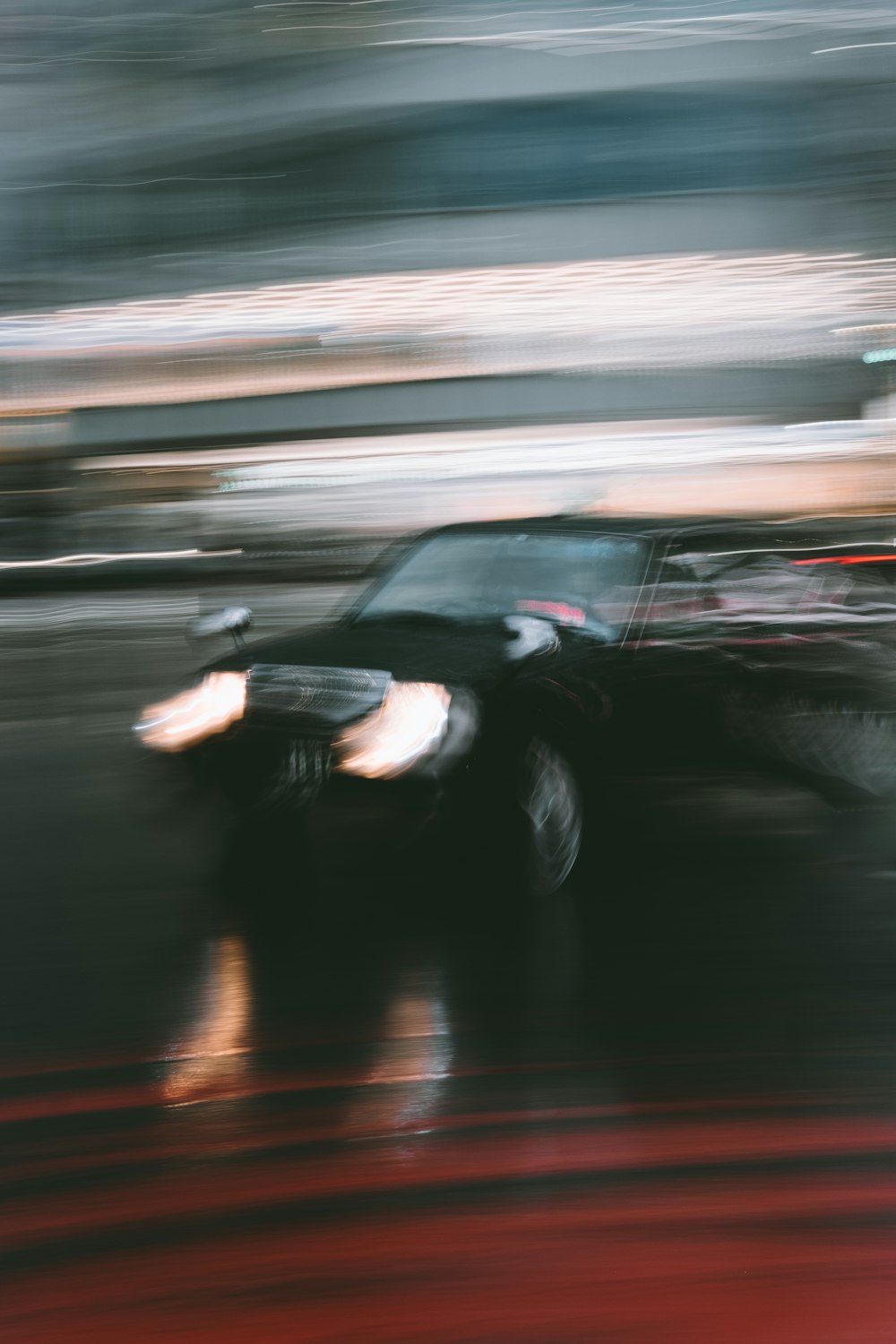 a blurry photo of a car driving down a street