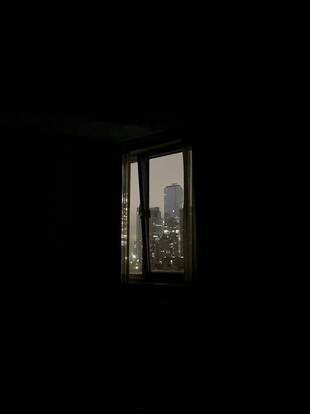 a window with a view of a city at night