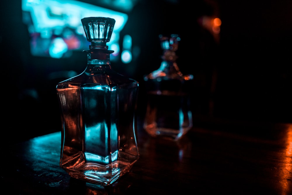 two glass decanters on table