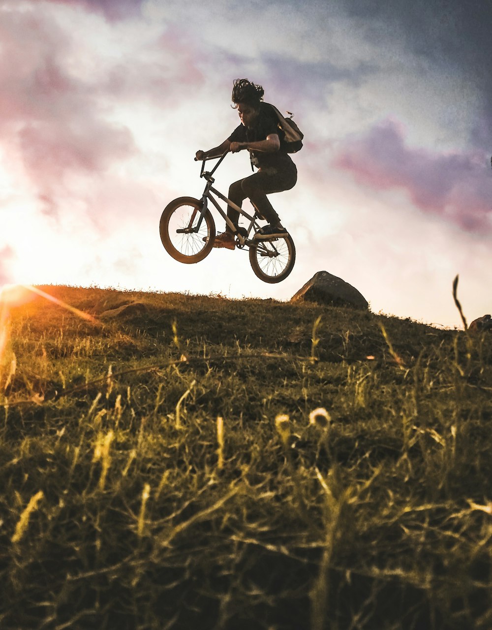 woman riding BMX bike at the hill