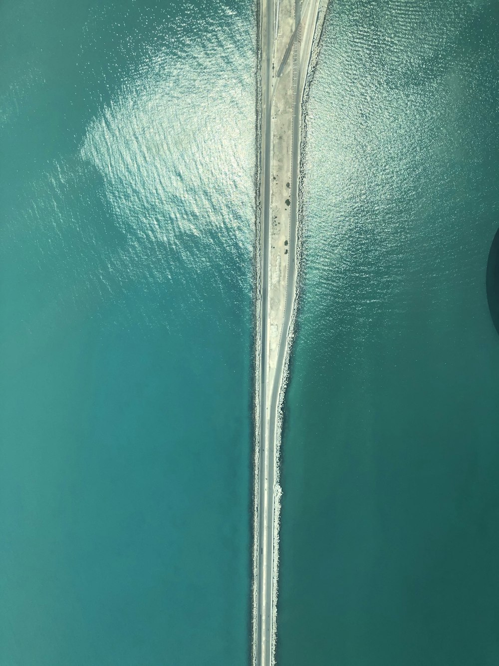 an aerial view of a bridge over a body of water