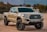 white Toyota crew cab pickup truck on ground