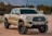 white Toyota crew cab pickup truck on ground