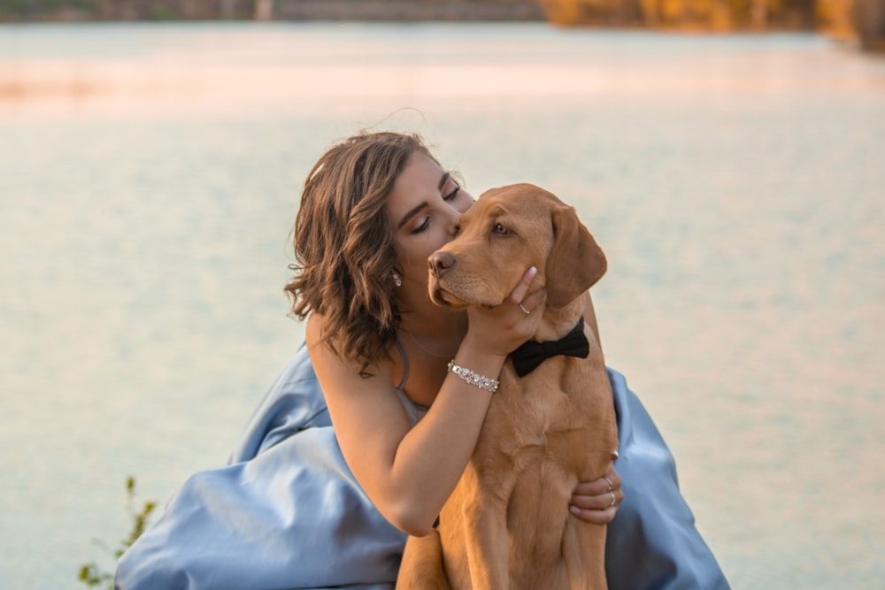 woman kissing dog