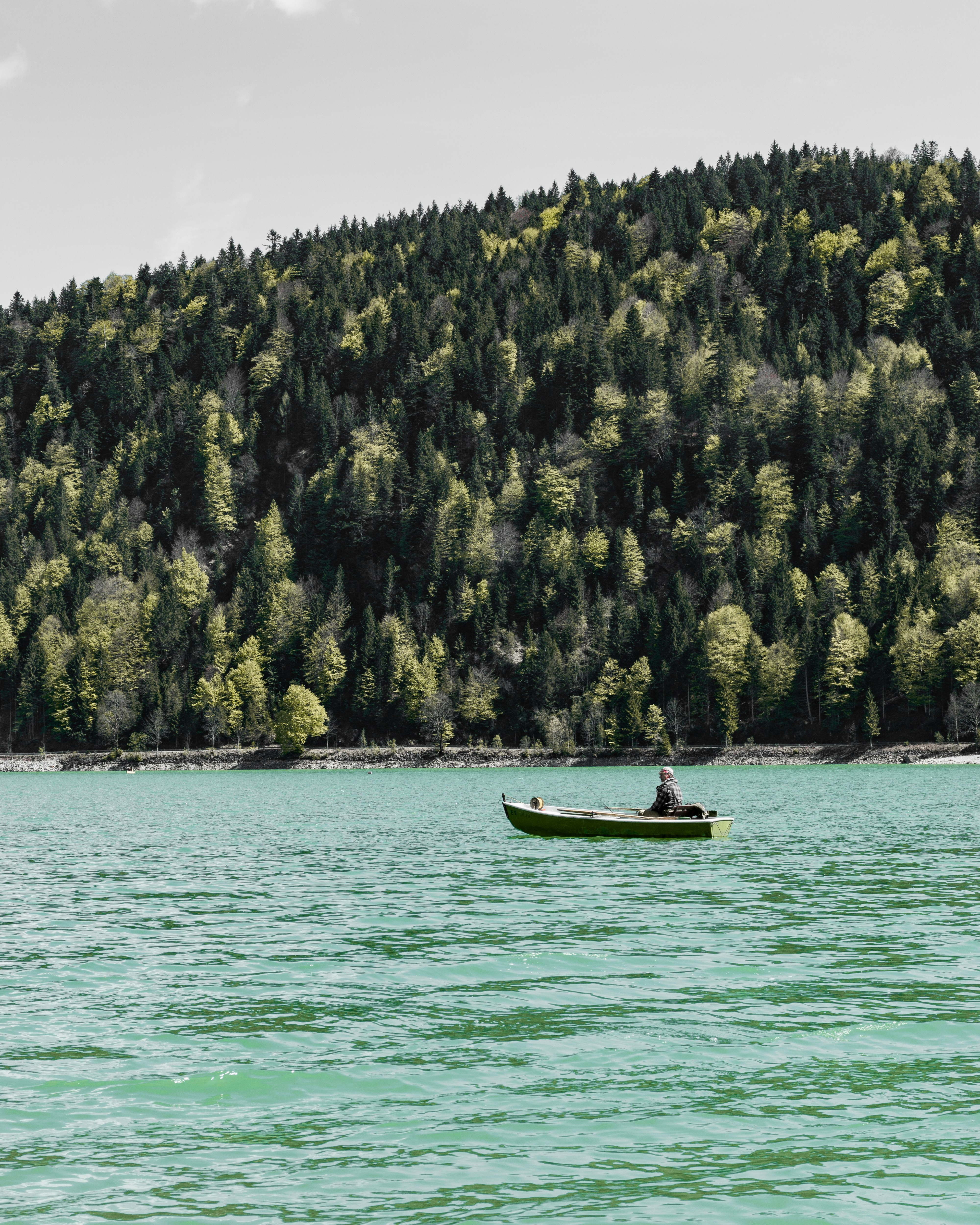 person riding on gray boat during daytime