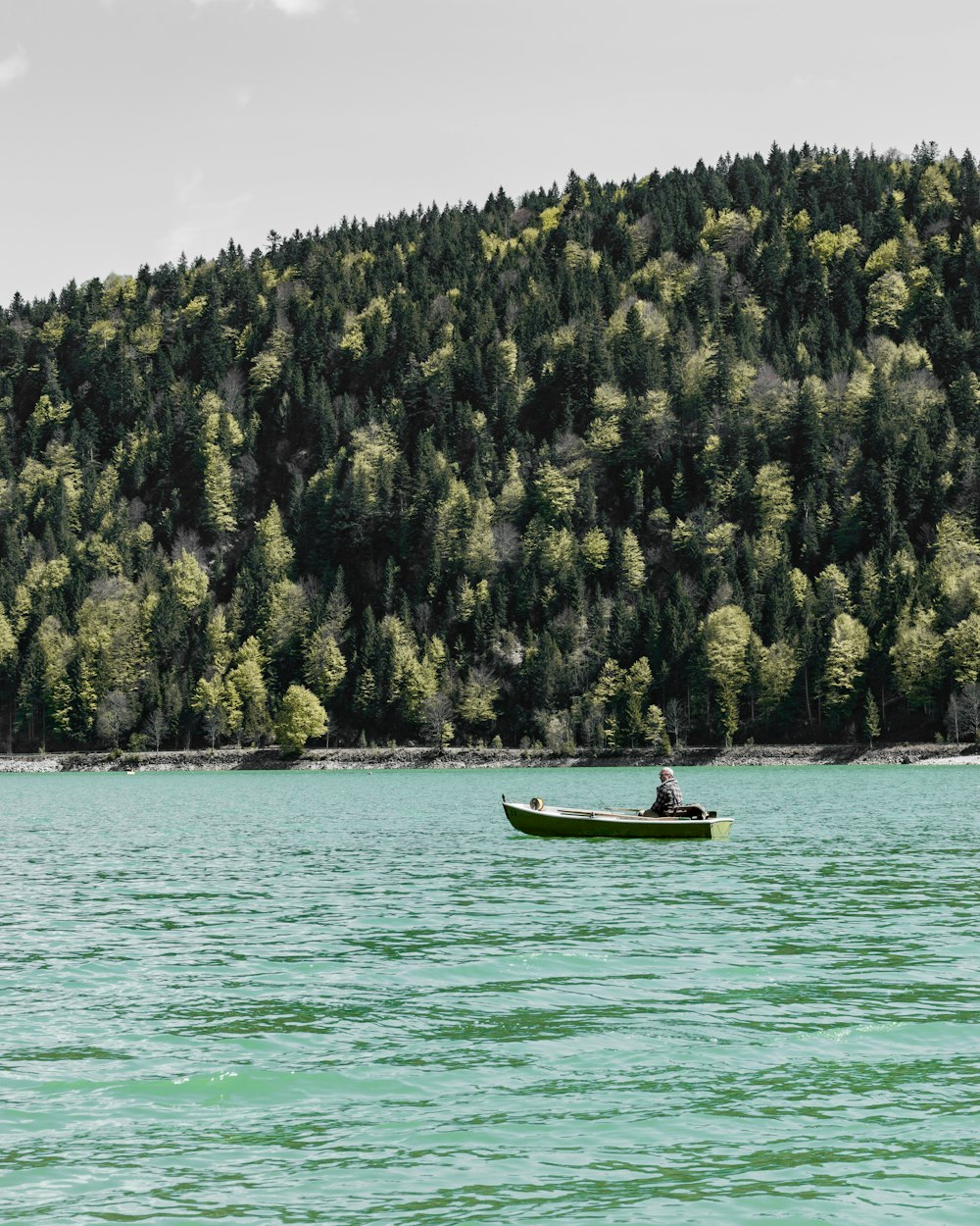 person riding on gray boat during daytime