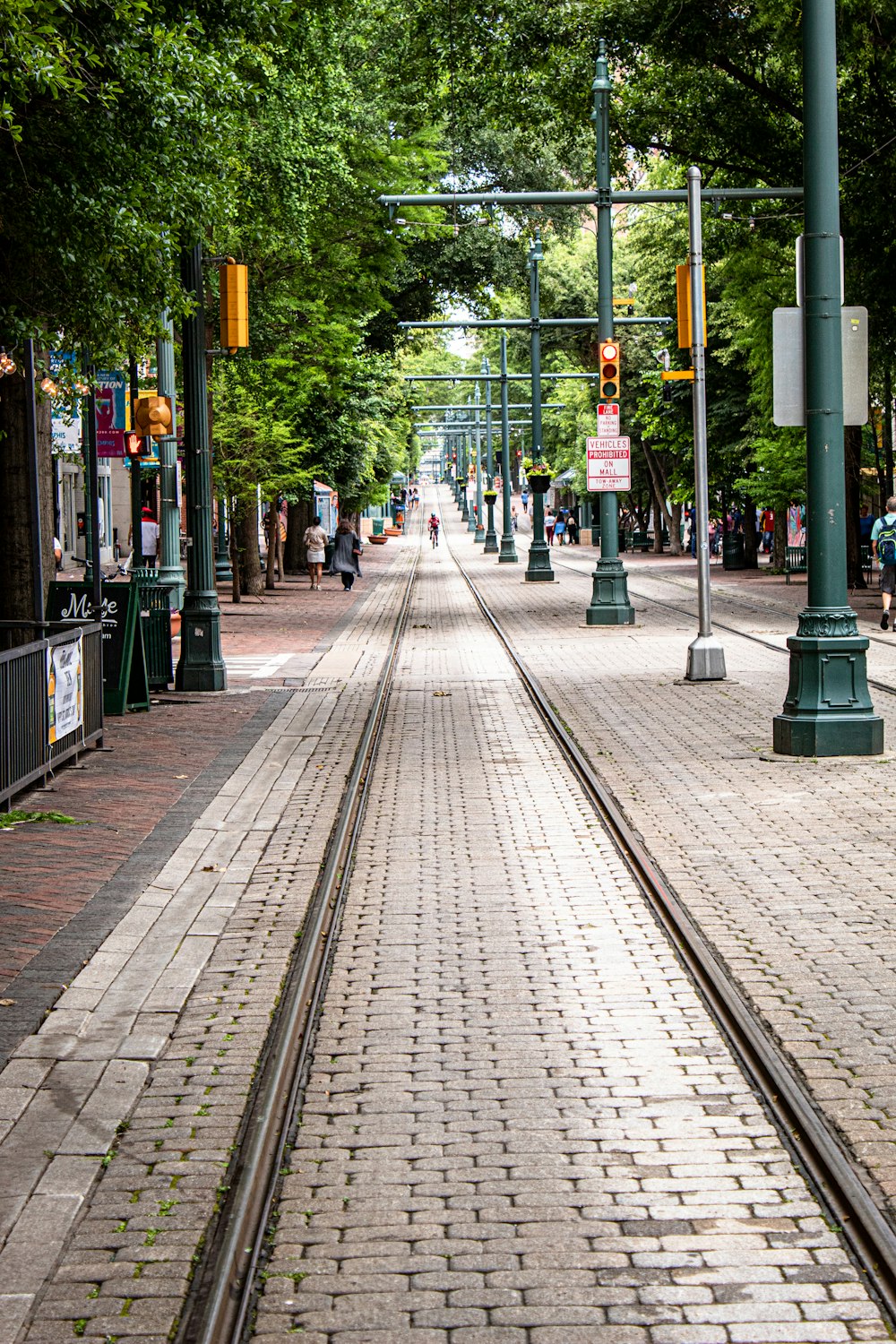 man in red walking in tram tracks