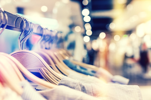 Line of shirts on wooden hangers