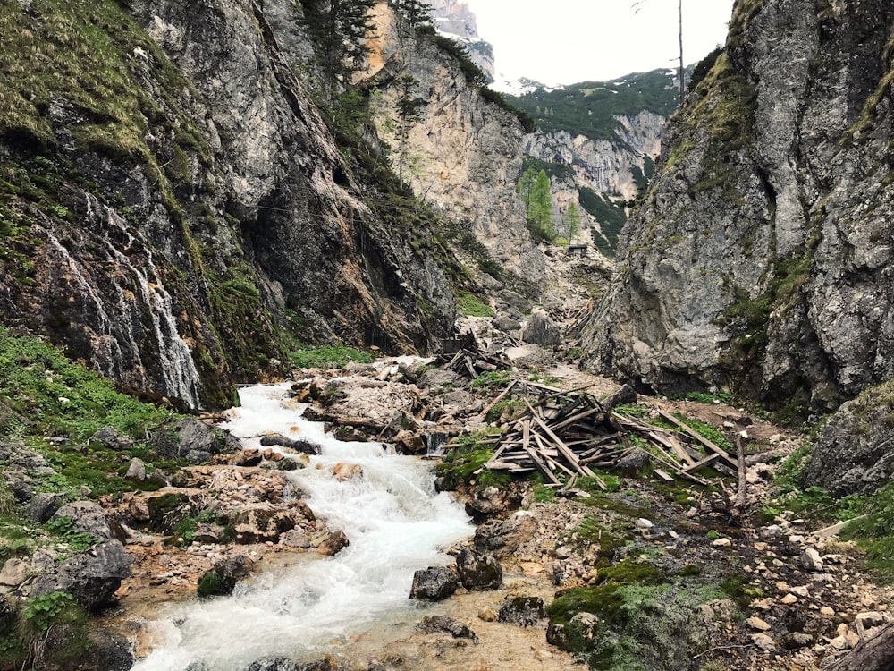 river between mountain during daytime