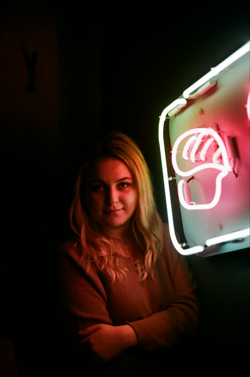 woman standing near white neon light signage