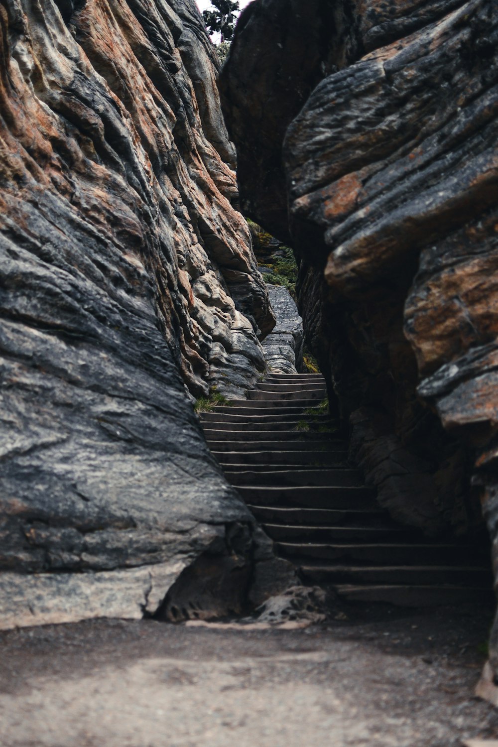 stair in between rock formation during daytime
