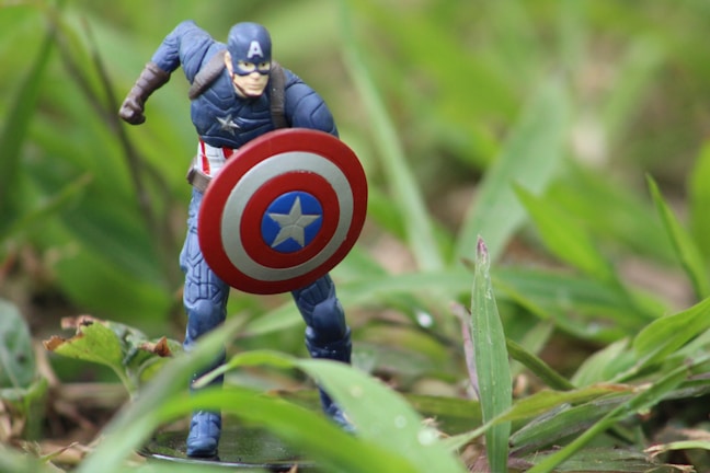 A vibrant Captain America costume with intricate shield details displayed on a stand.