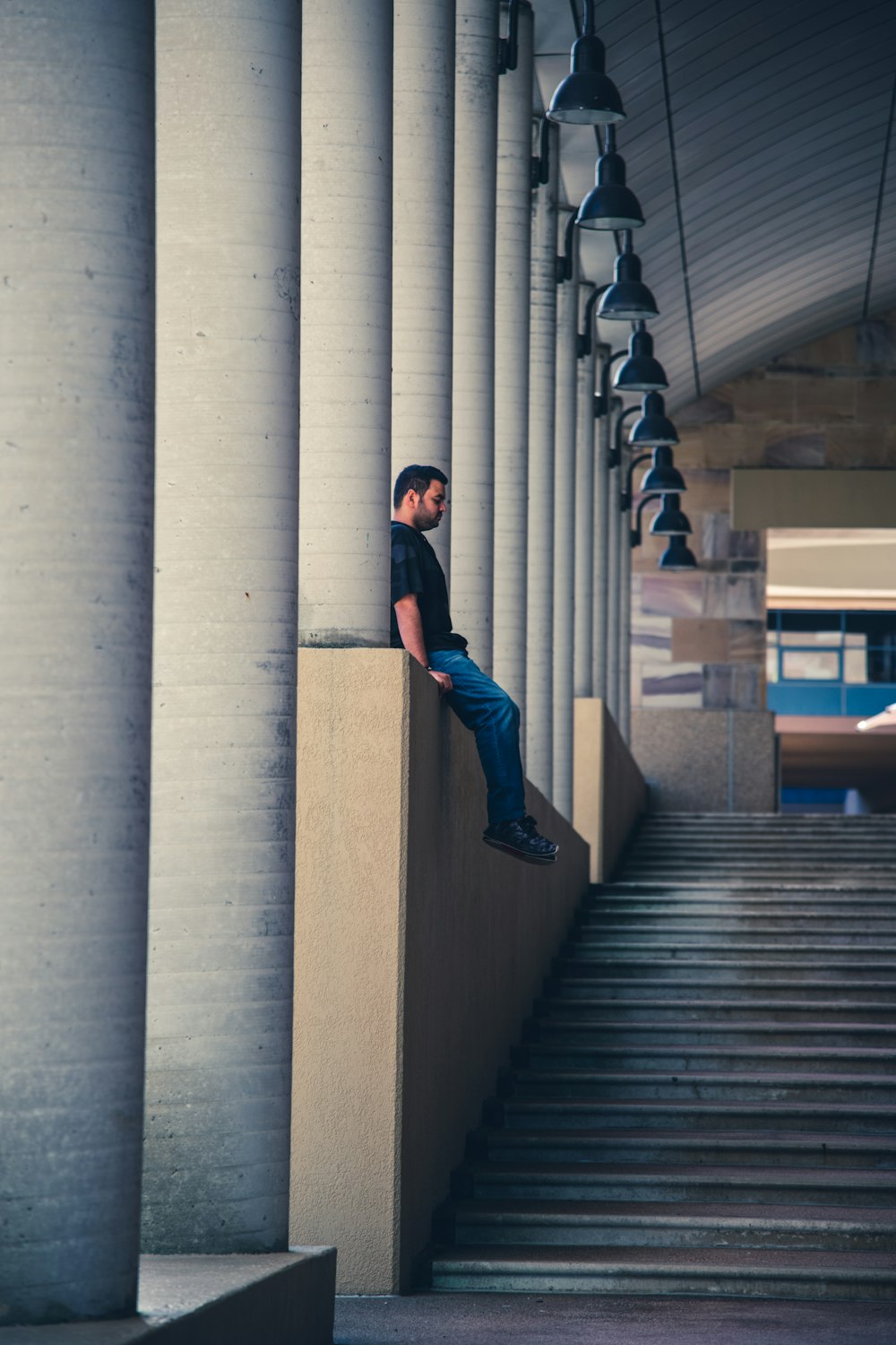 person sitting on wall during daytime