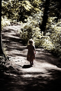 girl in dress standing on pathway
