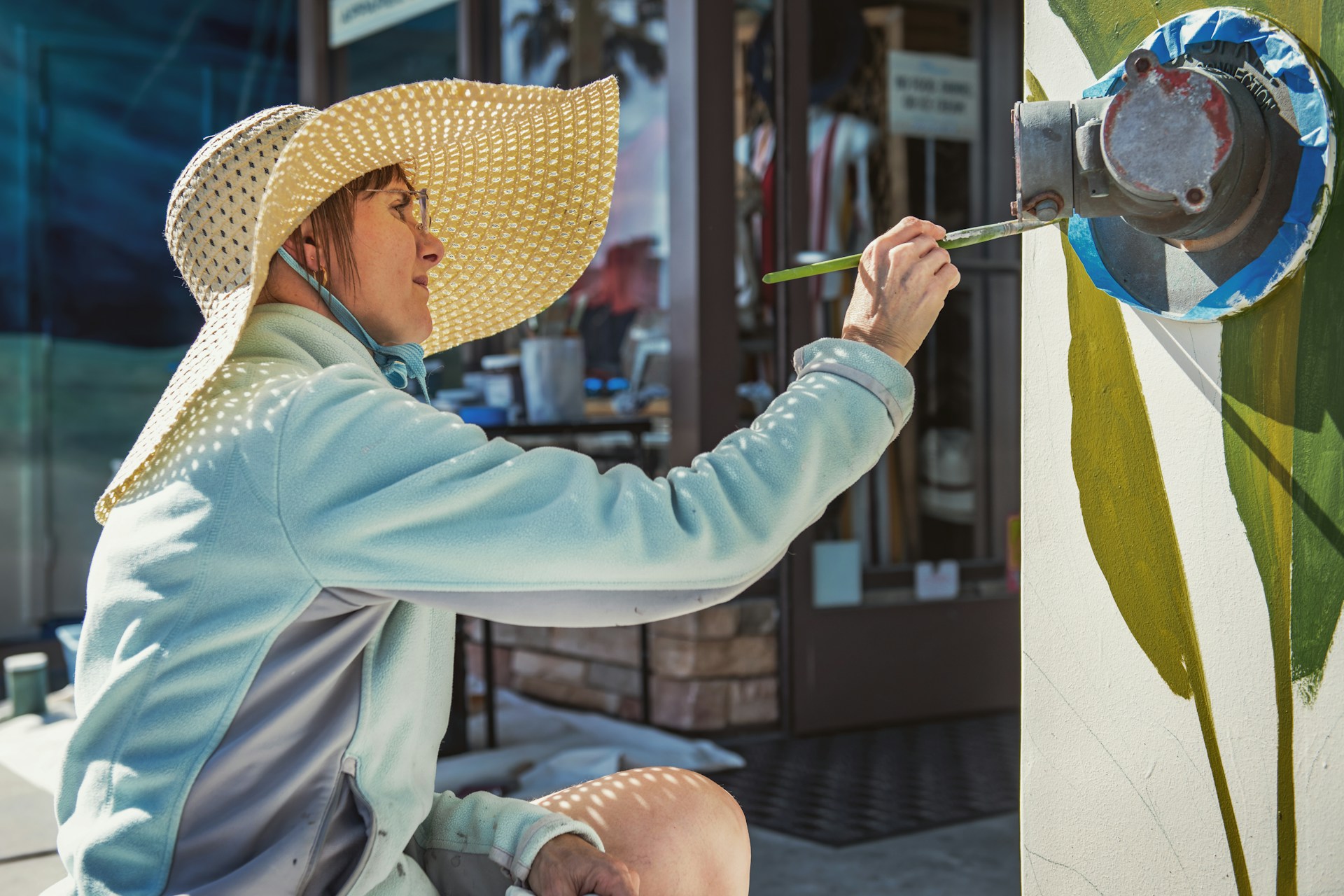 woman painting on wall