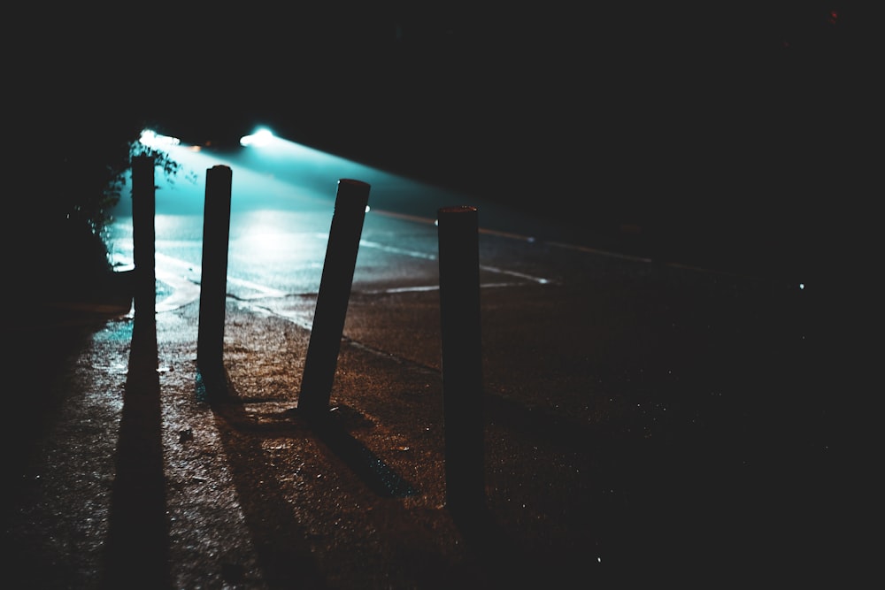 a row of wooden posts sitting on the side of a road