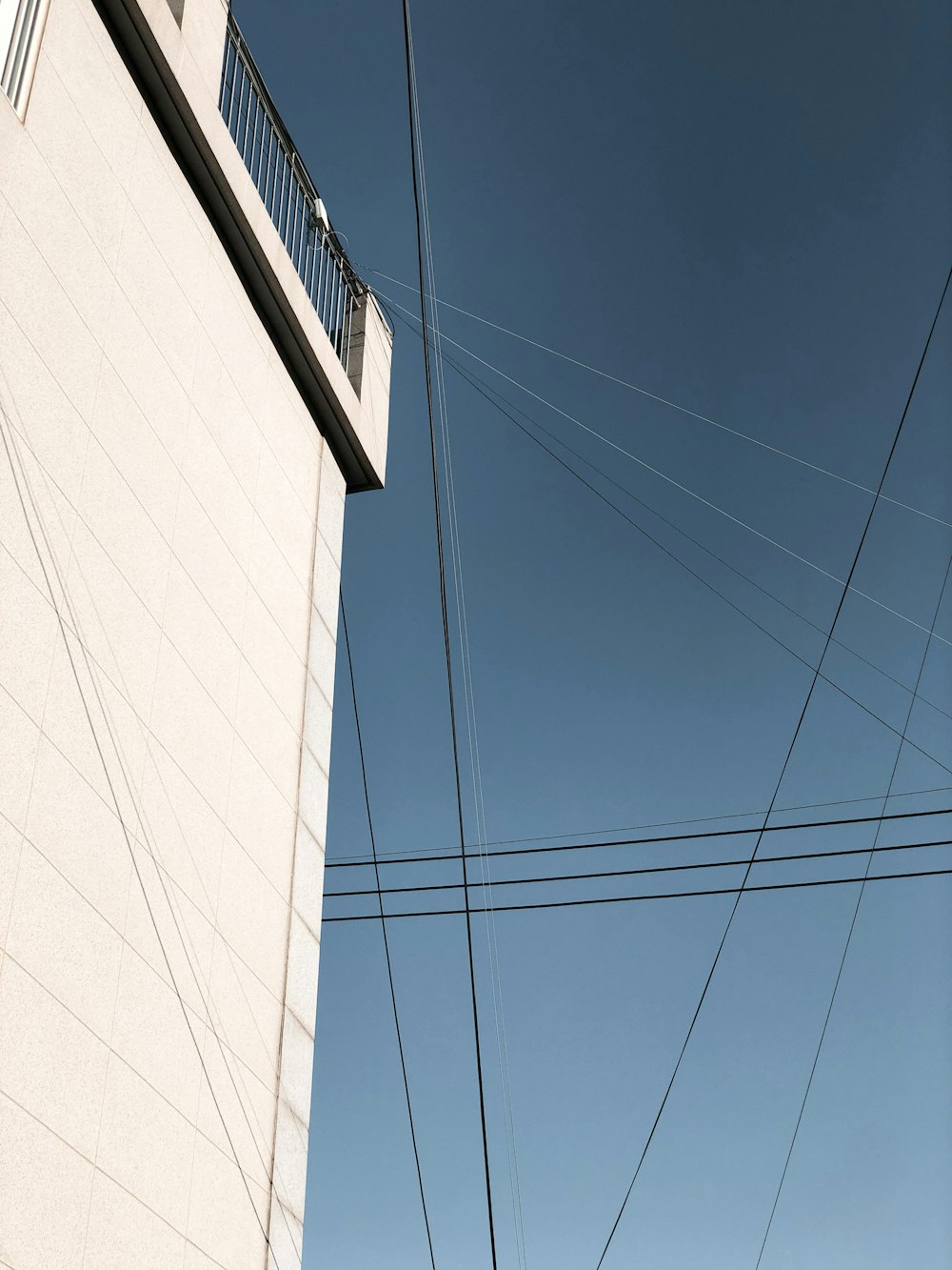 a tall building with power lines above it