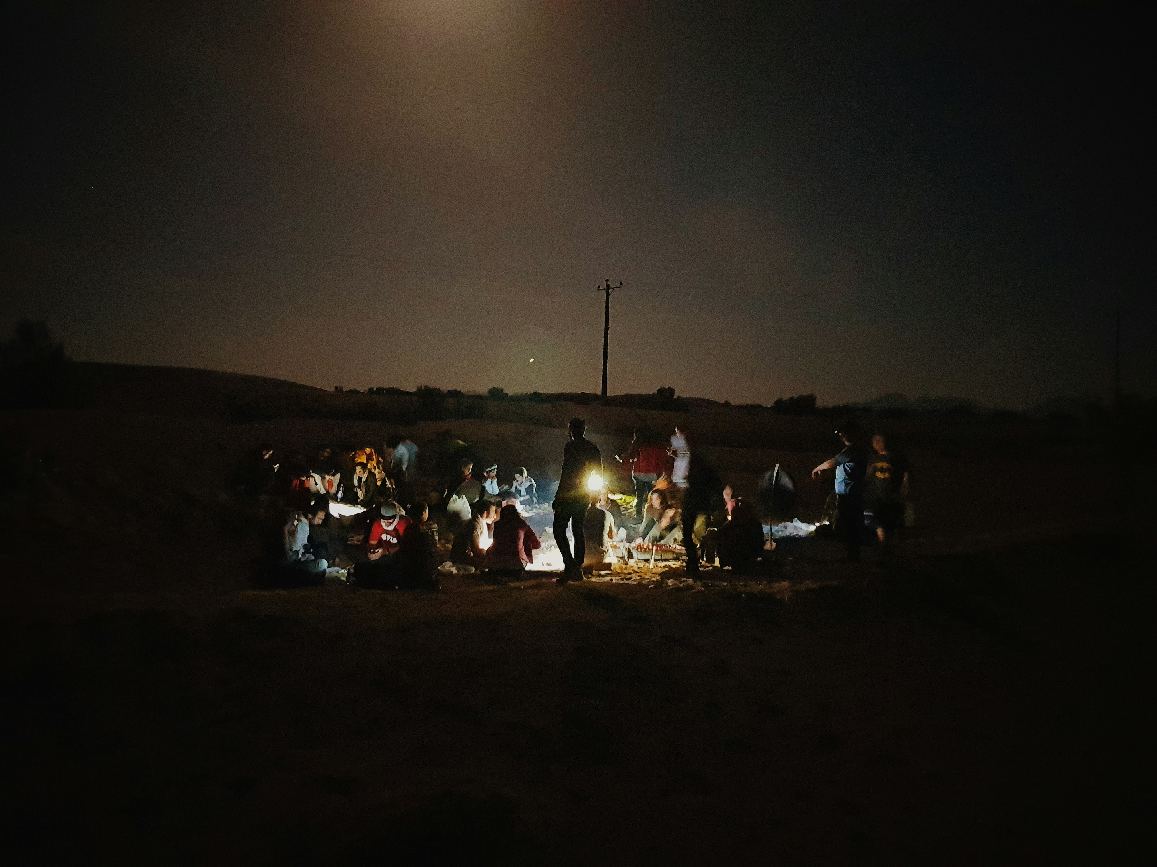 A group of people gathered around a makeshift aid station in Gaza, distributing supplies.