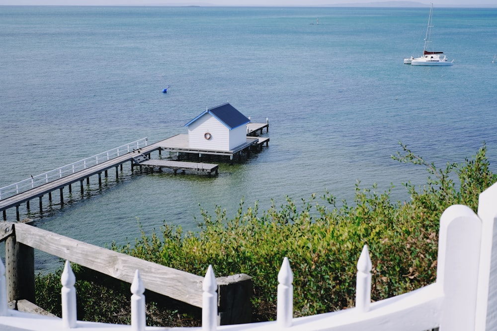 white wooden house beside body of water