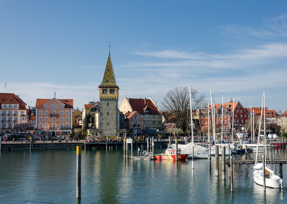 a harbor filled with lots of boats next to tall buildings