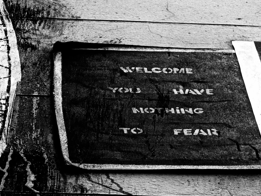 welcome you have nothing to fear sign on wooden surface