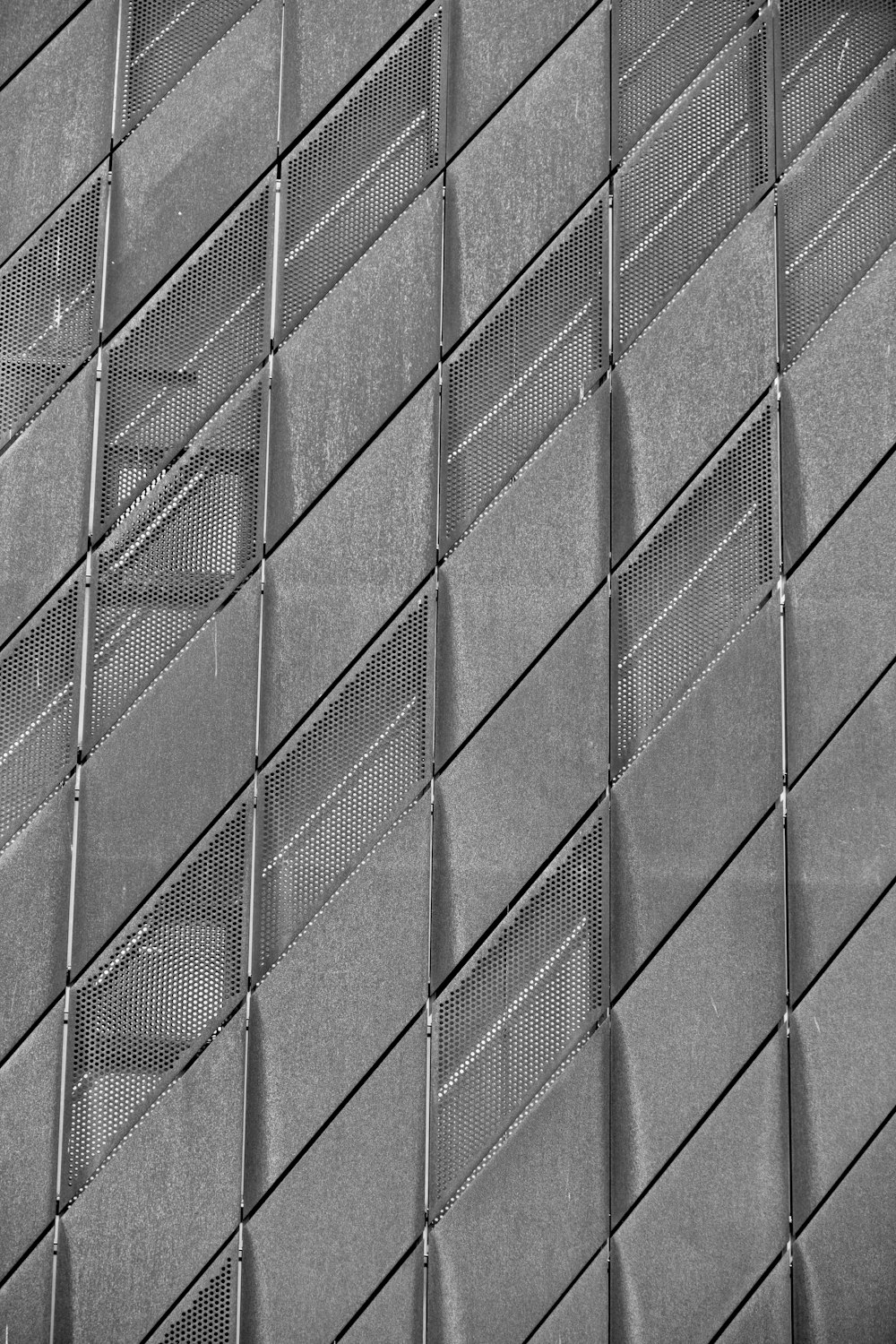 a black and white photo of a wall made of metal grates