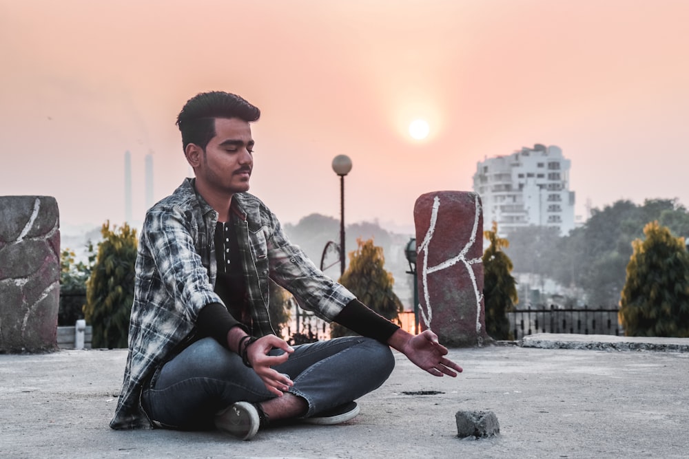 man sitting on concrete ground