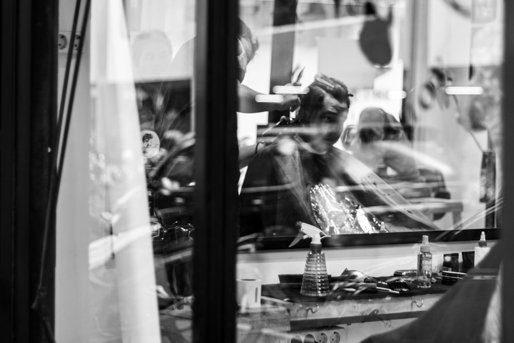 a black and white photo of people sitting in a restaurant