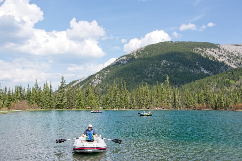 person riding white pedal boat