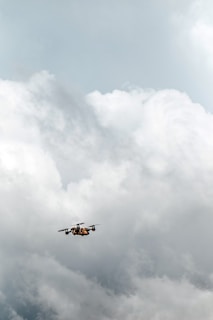 A drone soaring high above the clouds, demonstrating its capabilities.