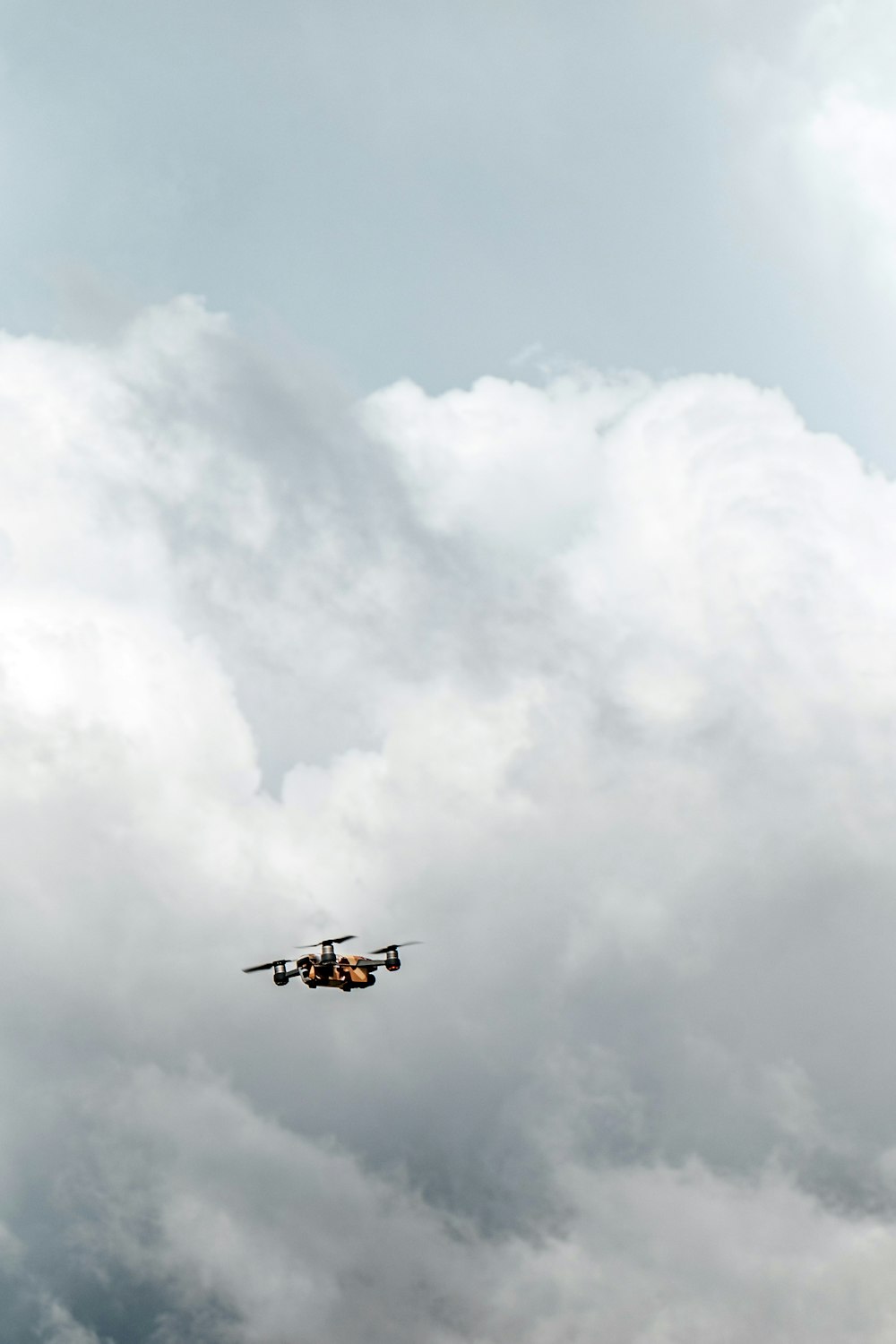 drone nero sotto nuvole bianche