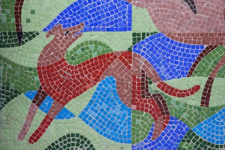 A vibrant collage showing a Bernese Mountain Dog, a sleek cat, and a playful elephant statue