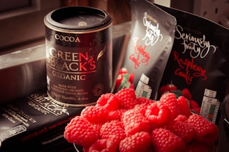 Cocoa Green & Black's can and bunch of raspberries