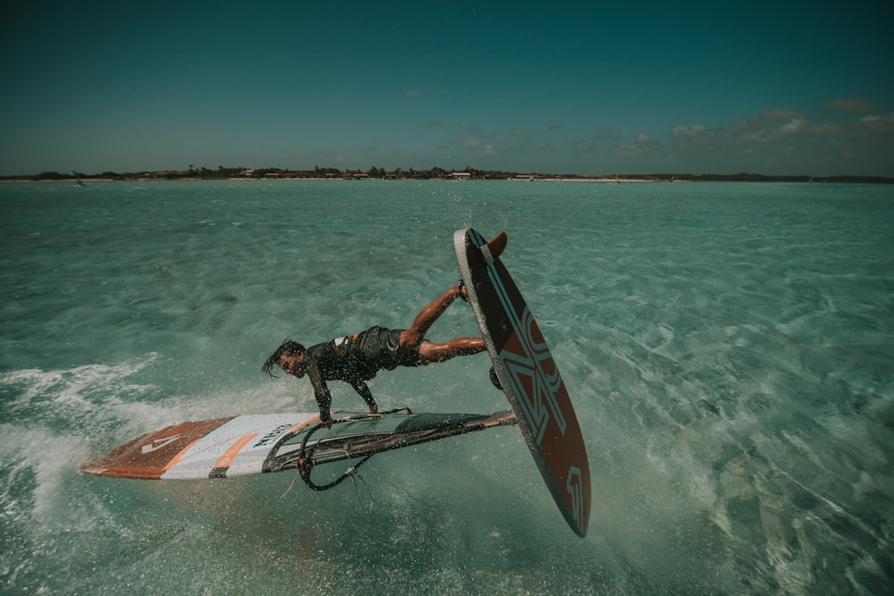 man doing stunt of surfboard